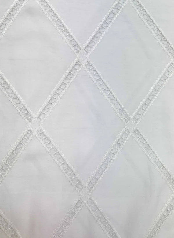 Close-up of a textured white fabric with diamond pattern