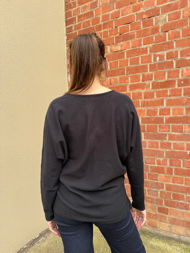 Stella wearing the black osteria V neck jumper by sunny girl